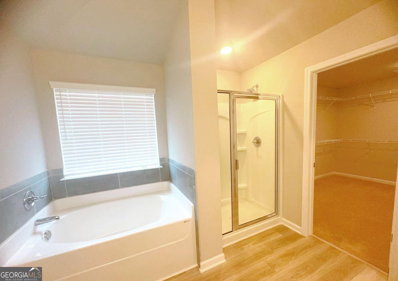 446 Sawmill Trace Hampton, GA 30228 - Photo 15 of 15 a bathroom with a bathtub and a shower