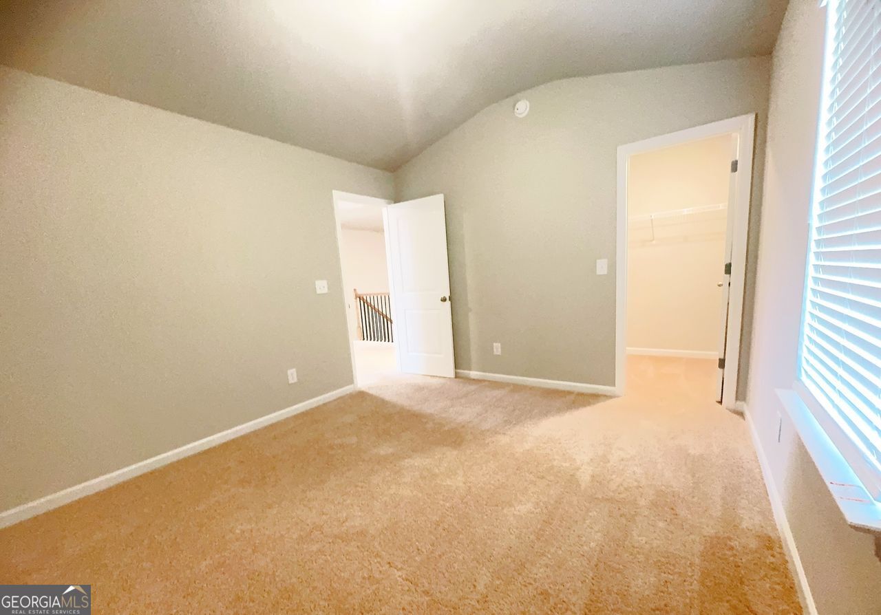 446 Sawmill Trace Hampton, GA 30228 - Photo 7 of 15 a view of an empty room and a window