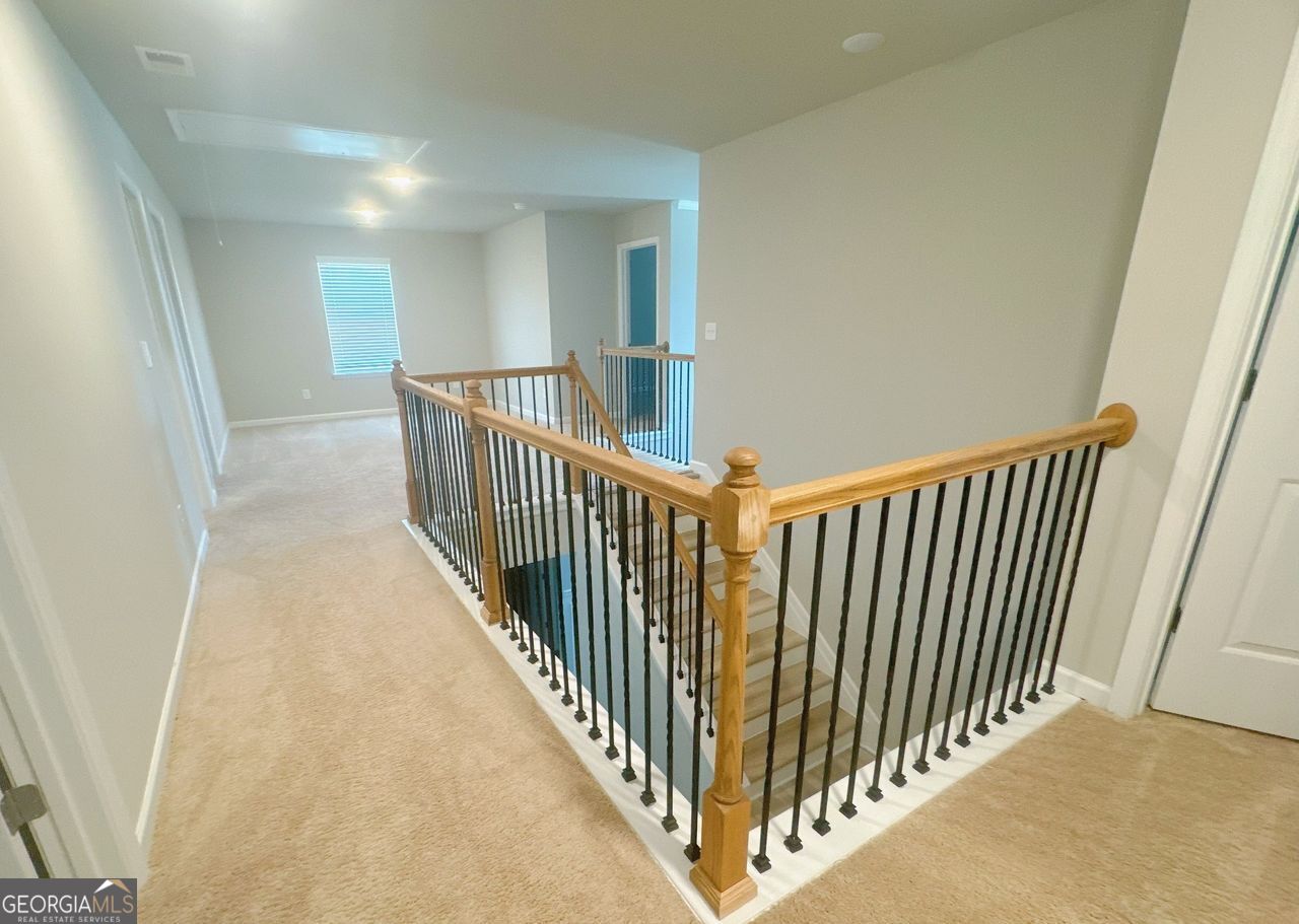 446 Sawmill Trace Hampton, GA 30228 - Photo 9 of 15 a view of a hallway with stairs