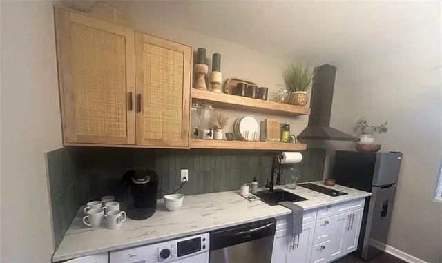 a room with a sink cabinets and utility