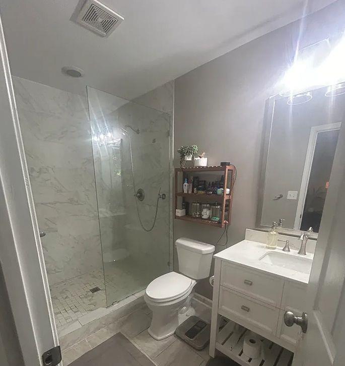 Undisclosed Address Decatur, GA 30032 - Photo 4 of 7 a bathroom with a sink toilet a mirror and shower