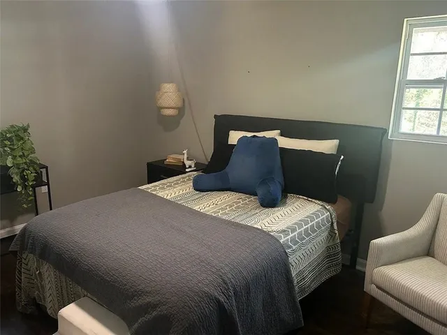 a bedroom with a bed and window