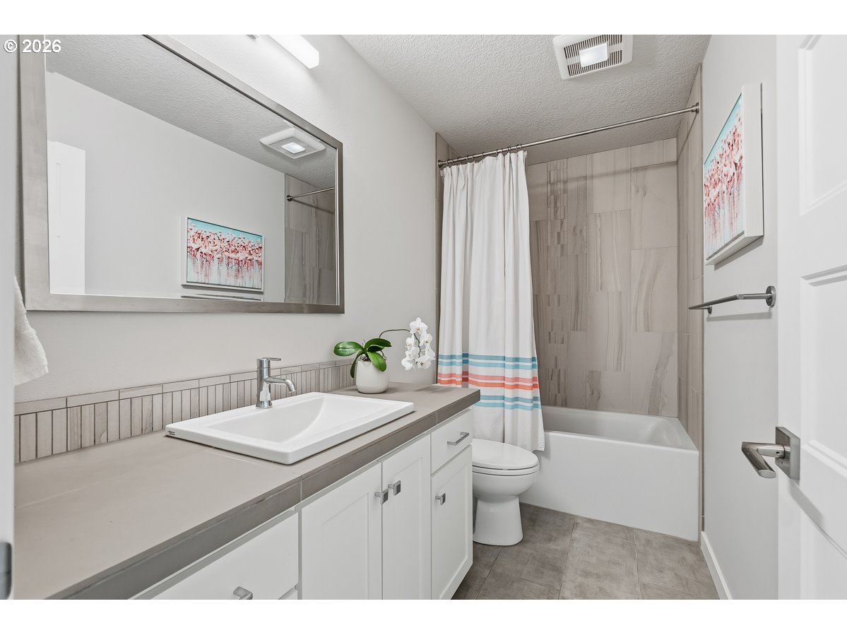 16275 Southwest Jade View Way Beaverton, OR 97007 - Photo 24 of 34 a bathroom with a sink a toilet a shower and a mirror