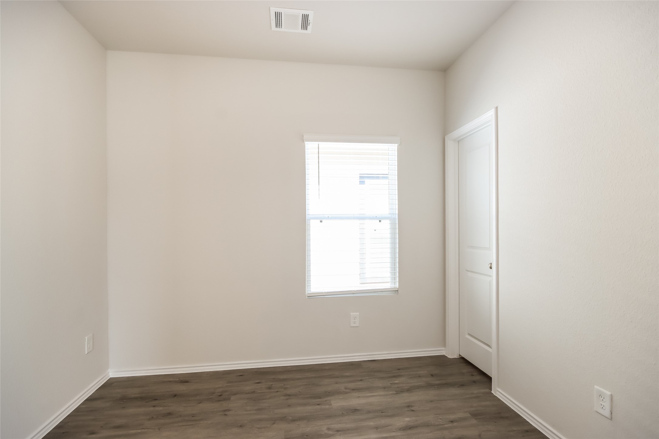 15226 Estrella Road West Houston, TX 77073 - Photo 10 of 13 an empty room with wooden floor and windows