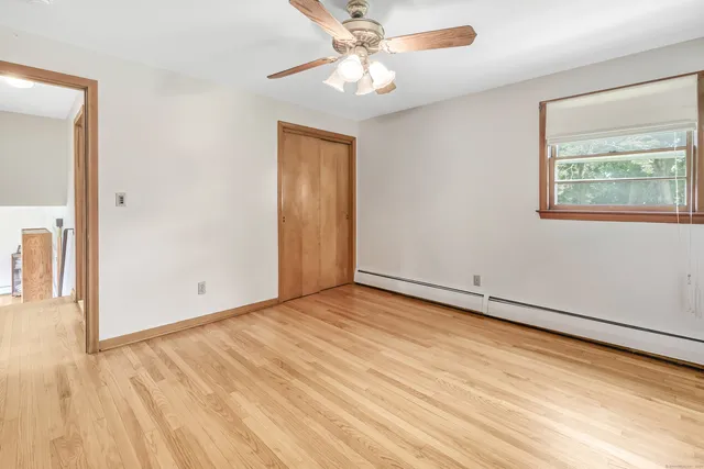 wooden floor in an empty room with a window