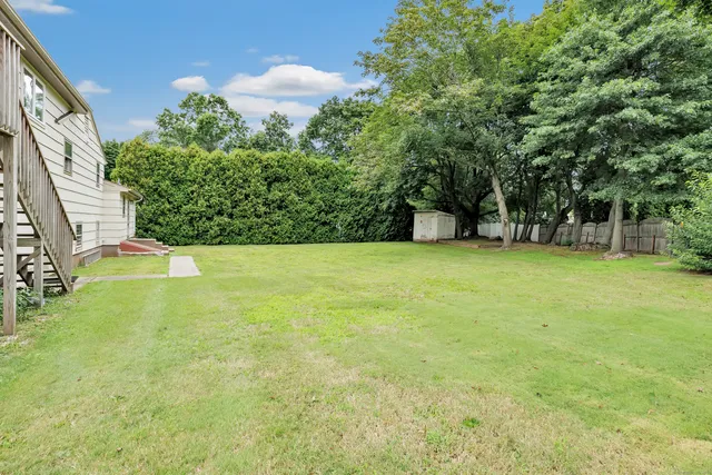 a view of yard with swimming pool and trees
