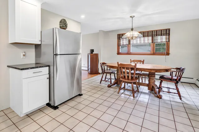 a kitchen with appliances cabinets and furniture