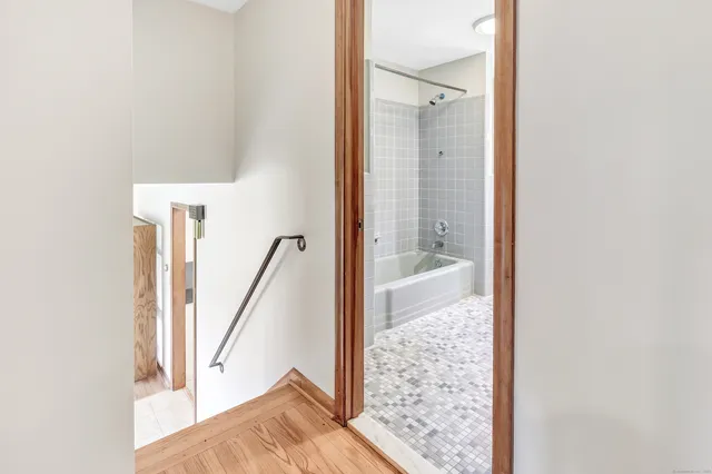 a view of a bathroom with tub and shower