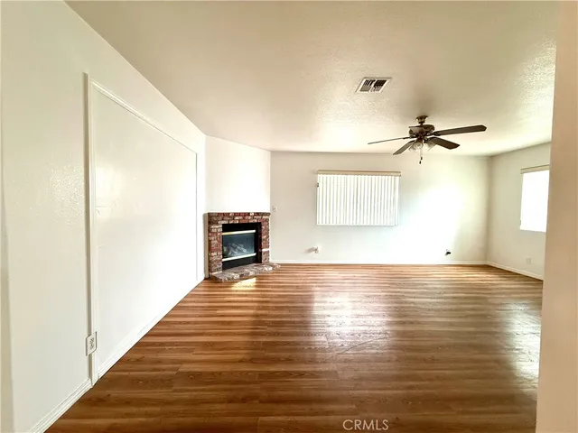 a kitchen with stainless steel appliances granite countertop a stove refrigerator and wooden floor