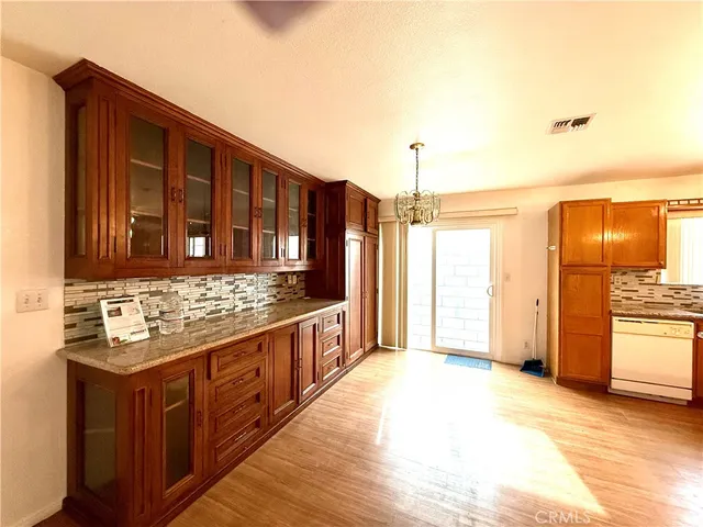 a kitchen with stainless steel appliances granite countertop a sink a refrigerator and a stove