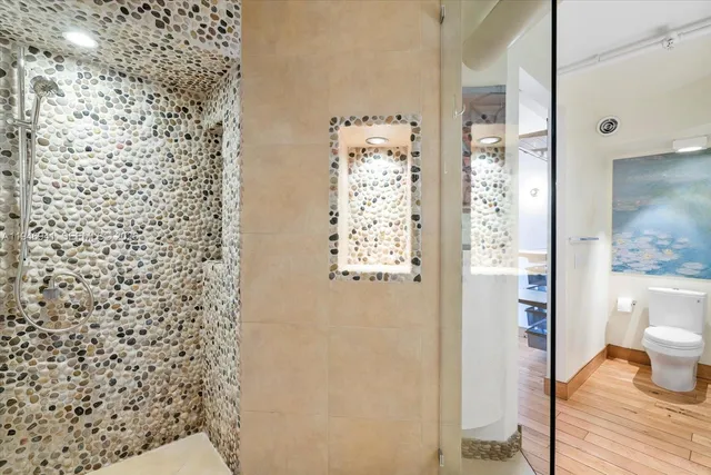 a kitchen with stainless steel appliances granite countertop a stove a refrigerator and a microwave