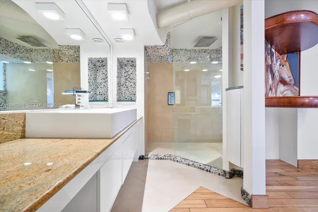 a large kitchen with stainless steel appliances granite countertop a large counter top and a stove