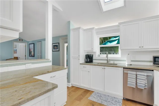 a spacious bathroom with a granite countertop sink and a mirror
