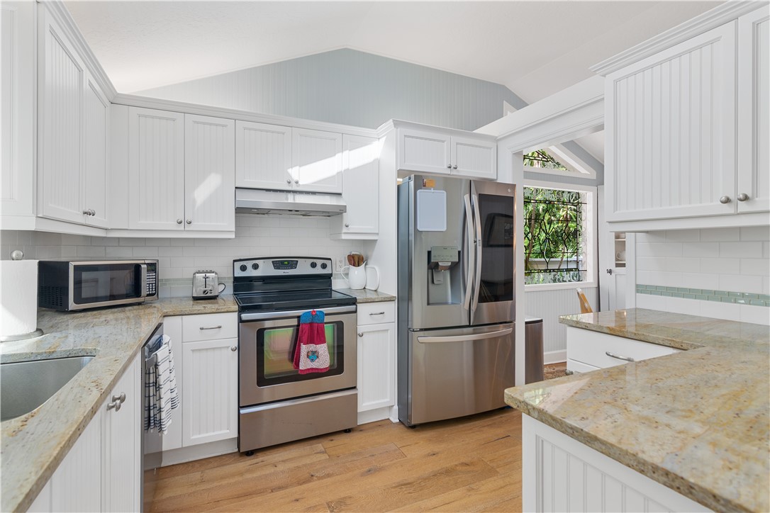 1971 Pebble Path Vero Beach, FL 32963 - Photo 12 of 36 a kitchen with stainless steel appliances granite countertop a stove and a refrigerator