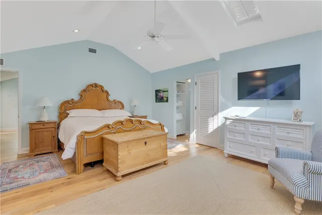 a bedroom with furniture and a flat screen tv
