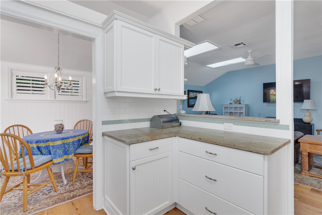 1971 Pebble Path Vero Beach, FL 32963 - Photo 10 of 36 a kitchen with stainless steel appliances granite countertop a sink and cabinets
