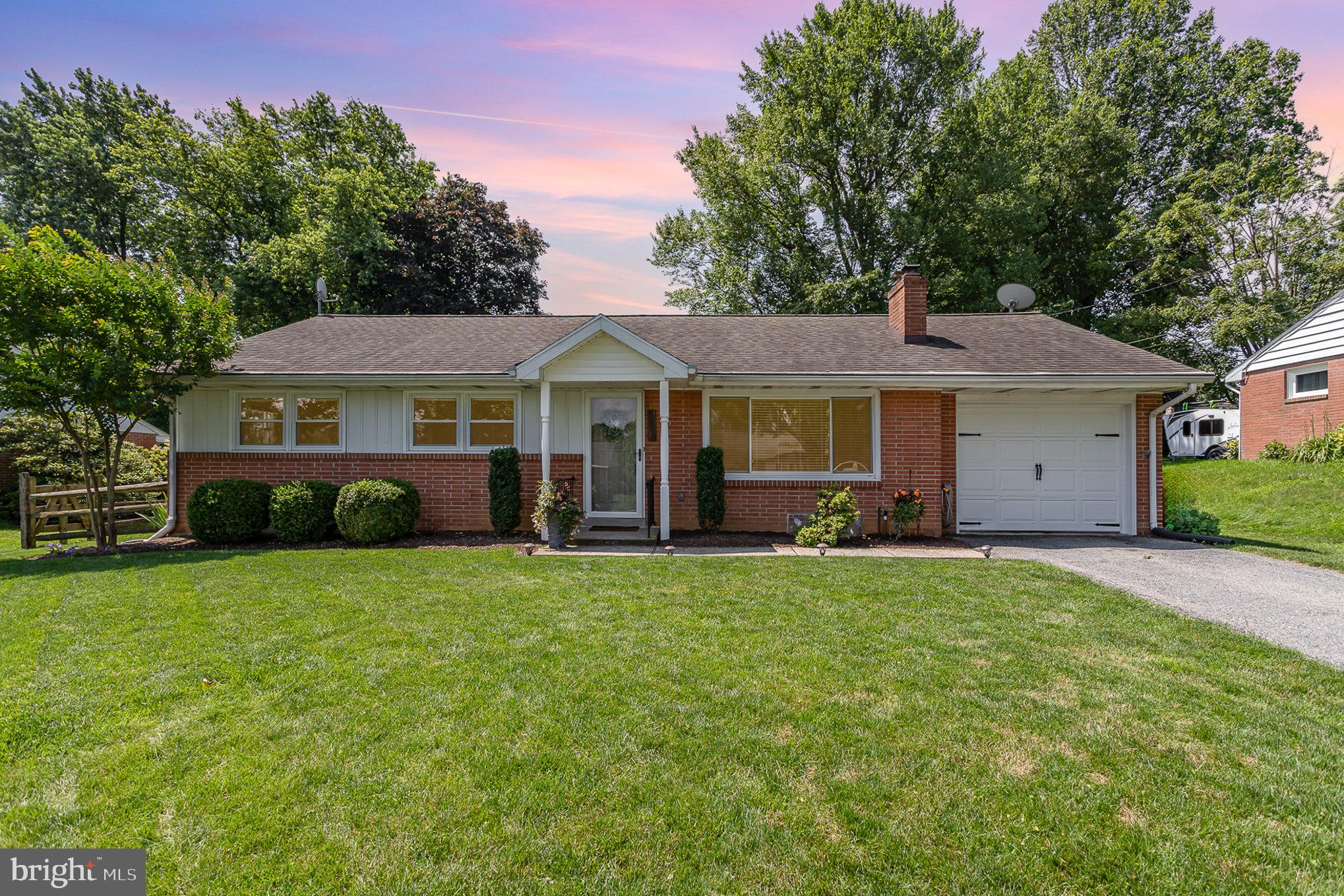 1556 Lambeth Road Lancaster, PA 17601 - Photo 1 of 42 a front view of a house with a yard and trees