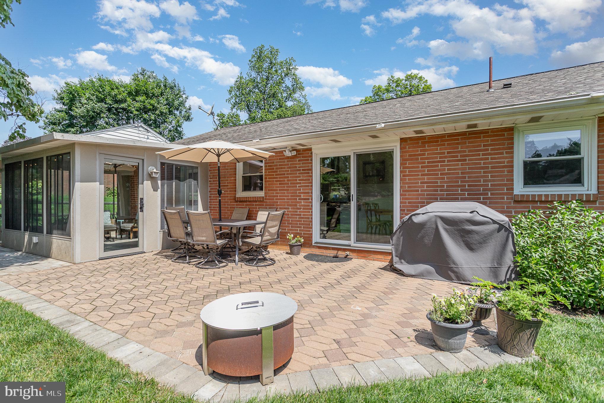 1556 Lambeth Road Lancaster, PA 17601 - Photo 32 of 42 a view of a patio with table and chairs potted plants and floor to ceiling window