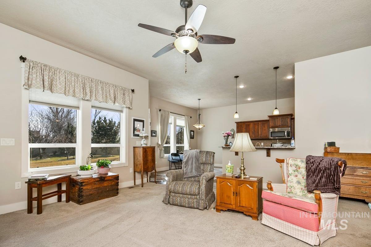1213 West Lowry Street Meridian, ID 83646 - Photo 13 of 38 Living room featuring light carpet, a ceiling fan, and recessed lighting
