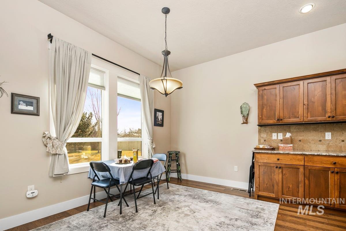 1213 West Lowry Street Meridian, ID 83646 - Photo 15 of 38 Dining space featuring dark wood-style floors
