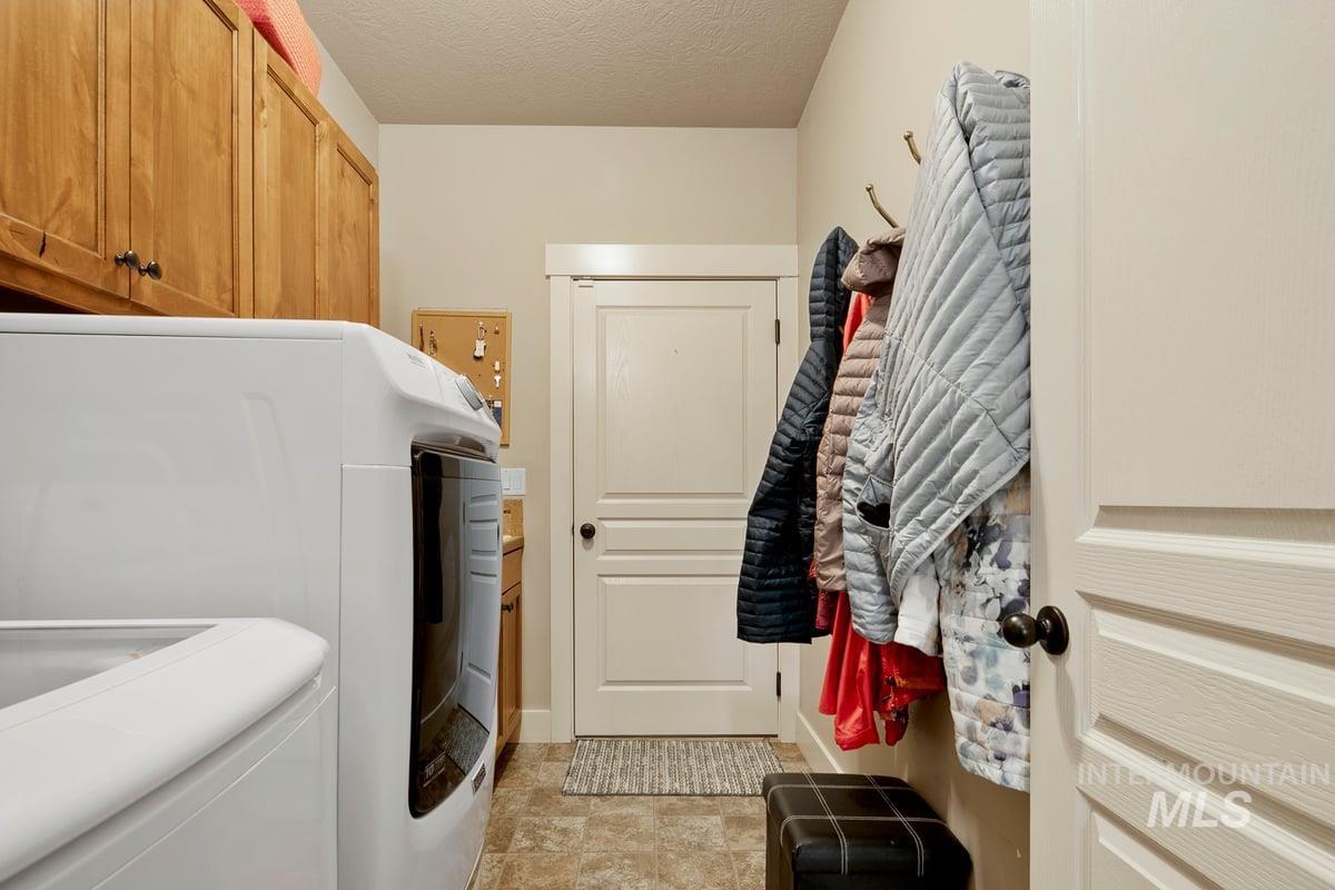 1213 West Lowry Street Meridian, ID 83646 - Photo 29 of 38 Laundry room with a textured ceiling, separate washer and dryer, and cabinet space