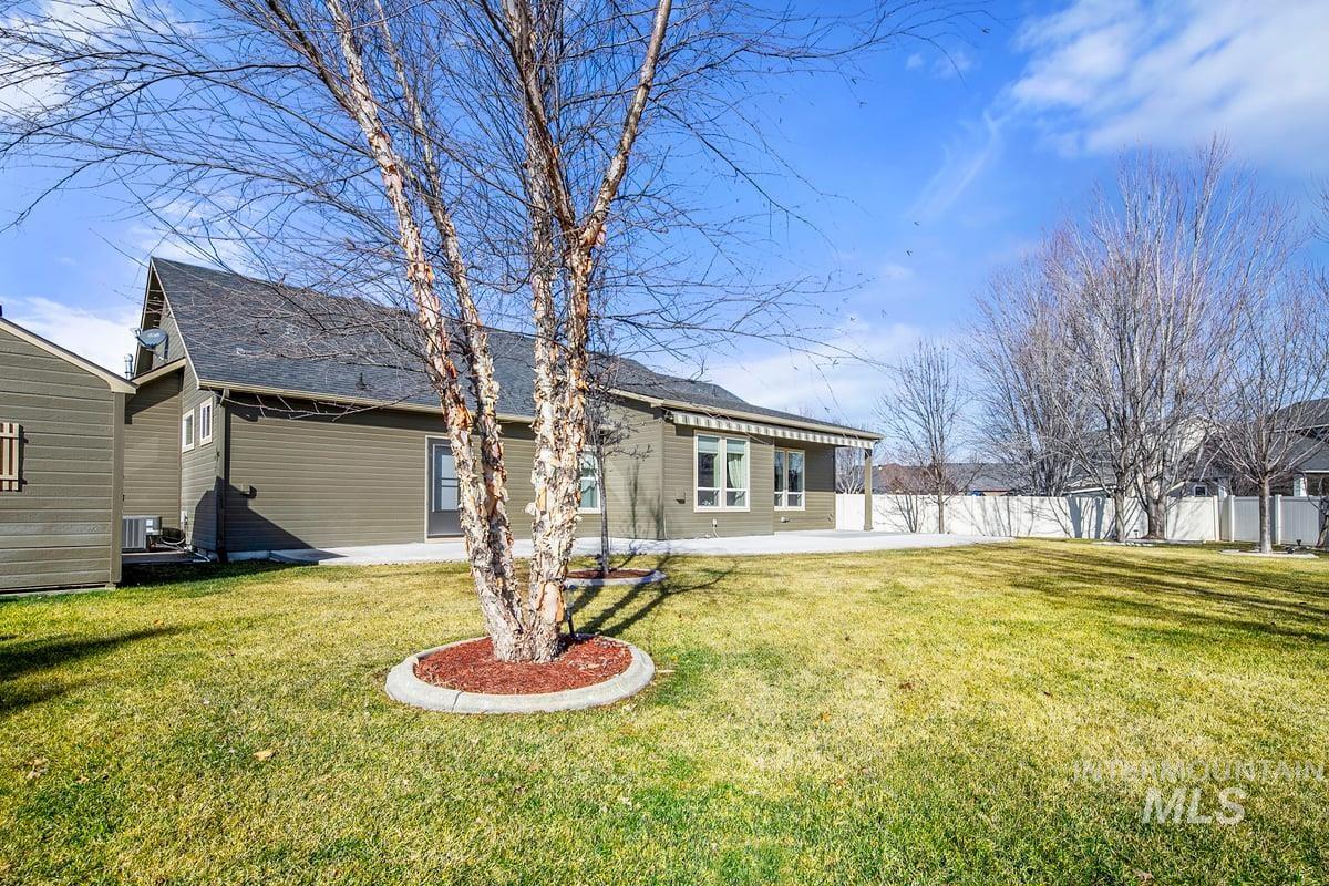1213 West Lowry Street Meridian, ID 83646 - Photo 33 of 38 Back of property featuring a patio area and roof with shingles