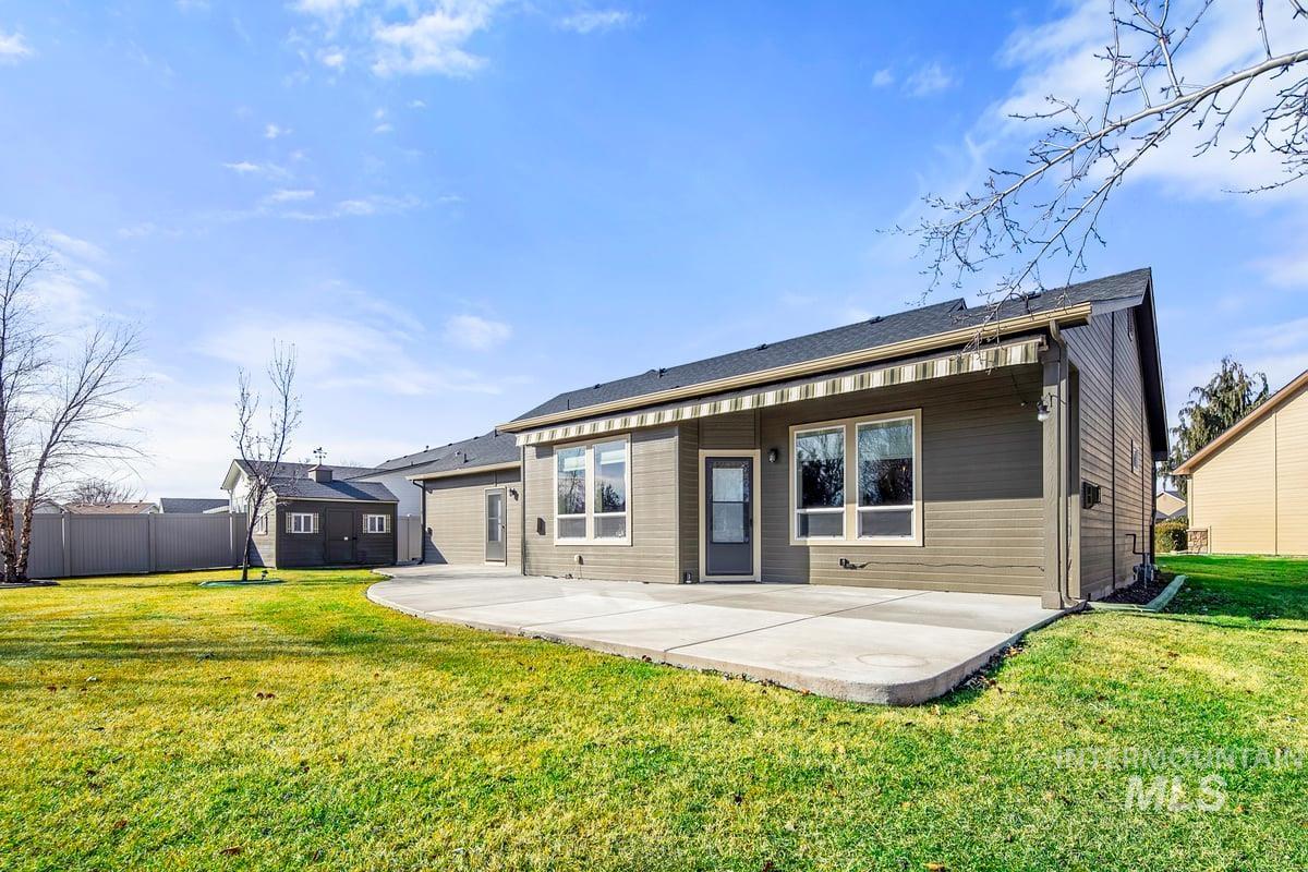 1213 West Lowry Street Meridian, ID 83646 - Photo 35 of 38 Back of property with a patio area and a yard
