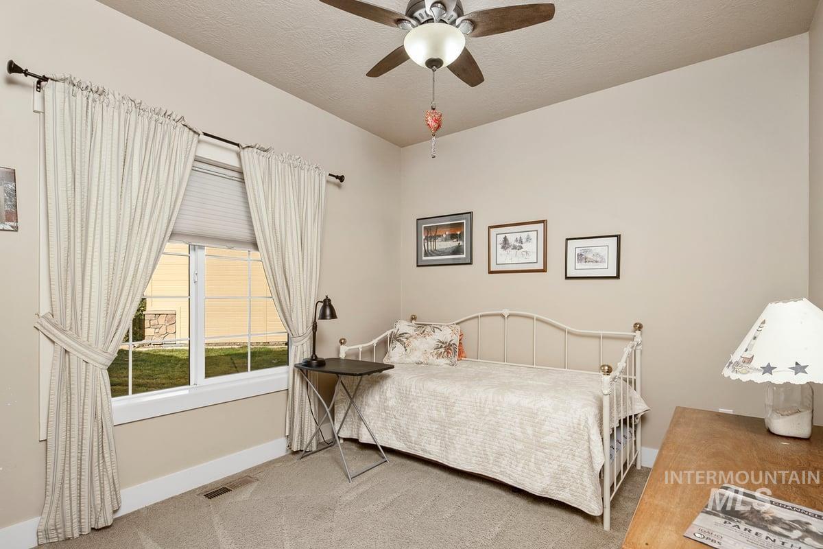 1213 West Lowry Street Meridian, ID 83646 - Photo 7 of 38 Carpeted bedroom featuring ceiling fan and a textured ceiling