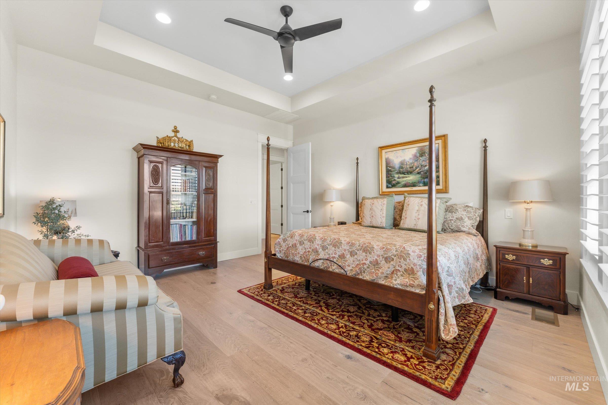 6585 South Pemberley Way Meridian, ID 83642 - Photo 23 of 43 Recessed lighting illuminates the tray ceiling and wood-finish flooring