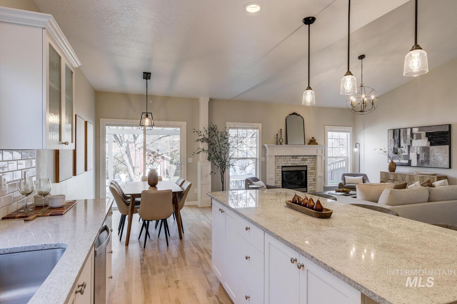 5572 West School Ridge Road Boise, ID 83714 - Photo 14 of 50 Kitchen with white cabinets, light stone counters, pendant lighting, light wood-type flooring, and recessed lighting