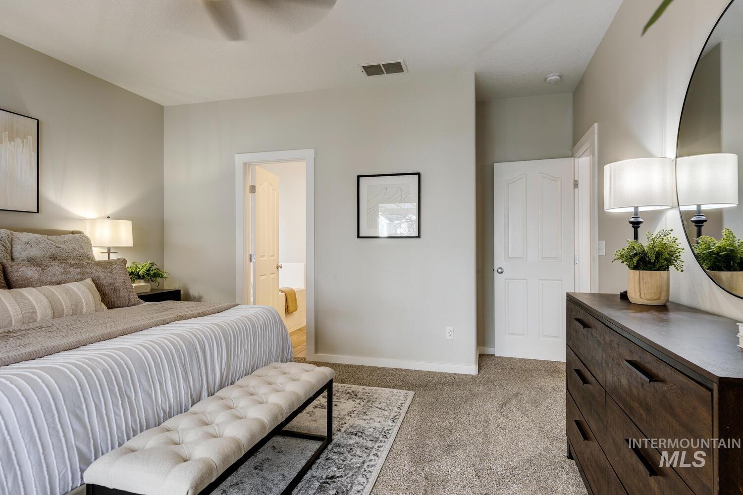 5572 West School Ridge Road Boise, ID 83714 - Photo 17 of 50 Bedroom featuring connected bathroom, light colored carpet, and a ceiling fan