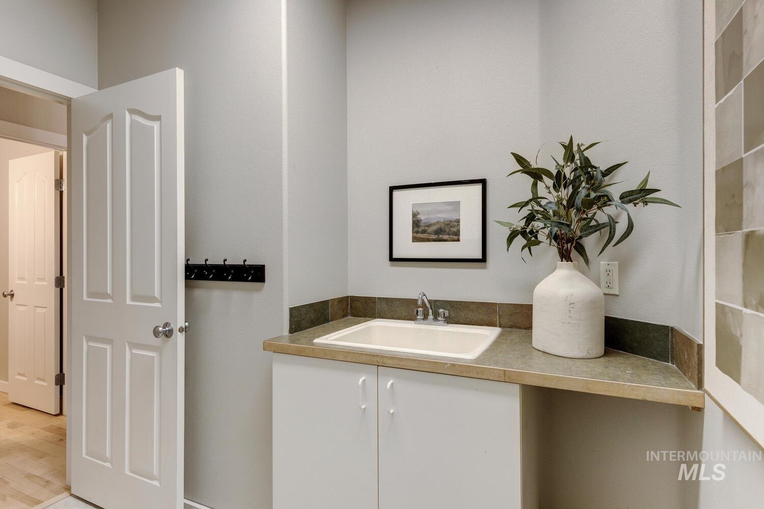 5572 West School Ridge Road Boise, ID 83714 - Photo 35 of 50 Bar area featuring white cabinetry and a sink