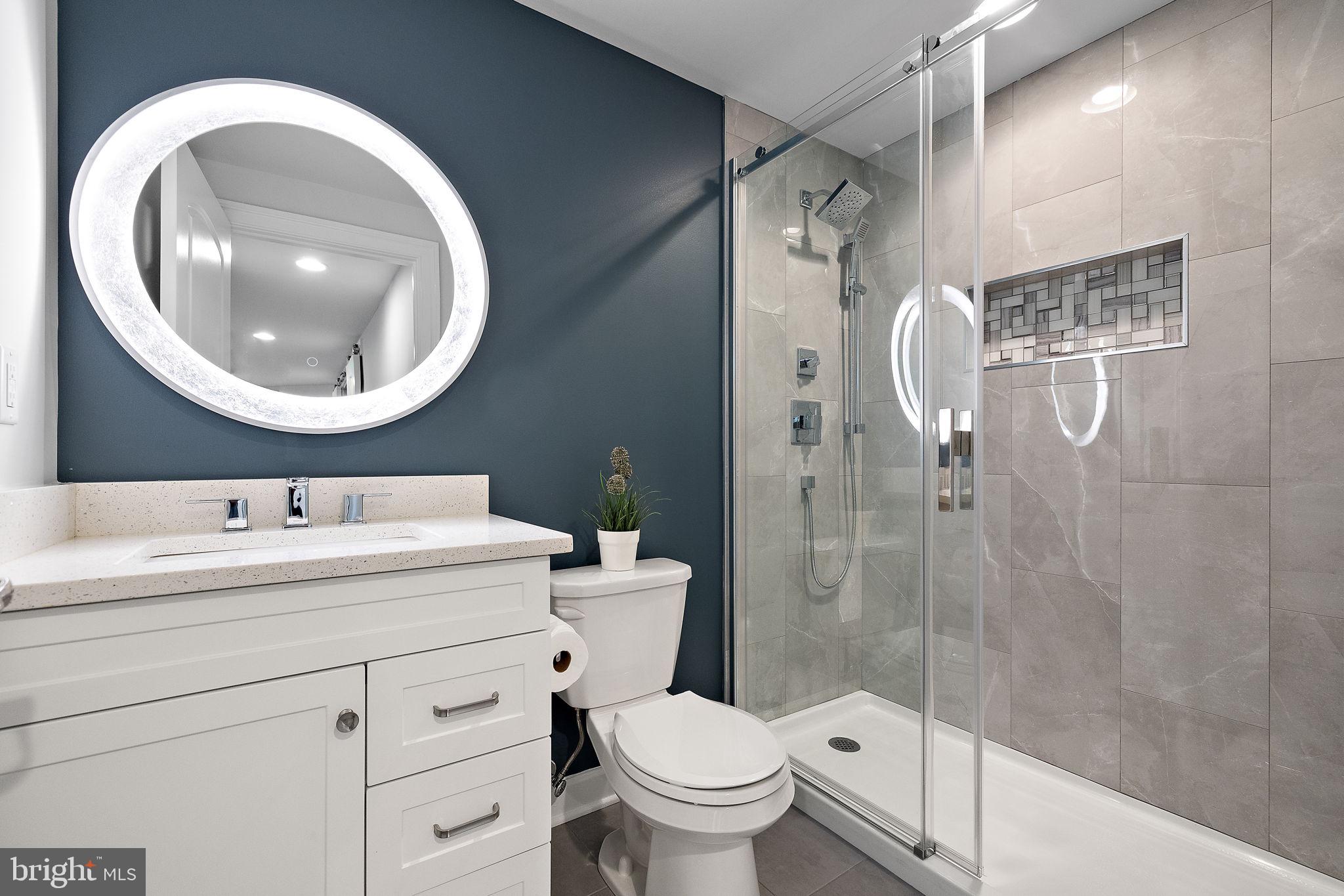 713 Stonecliffe Road Malvern, PA 19355 - Photo 46 of 56 a bathroom with a toilet sink vanity granite and mirror