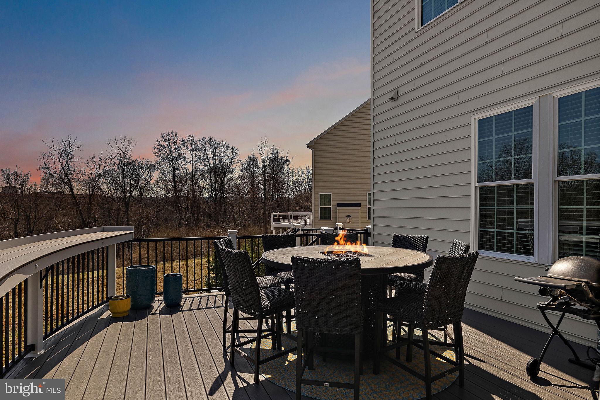 713 Stonecliffe Road Malvern, PA 19355 - Photo 50 of 56 a view of a roof deck with table and chairs with wooden floor and fence