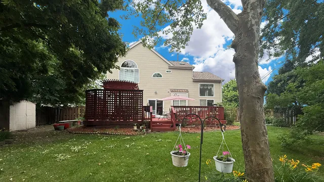 a view of a house with backyard and sitting area