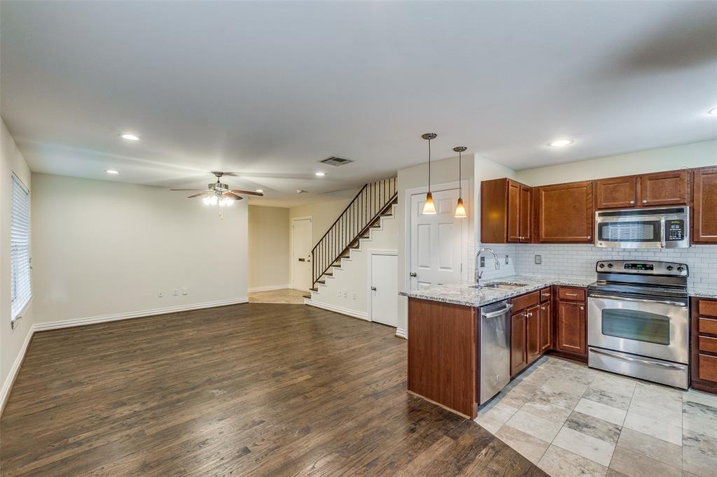 an open kitchen with stainless steel appliances granite countertop a stove and a sink