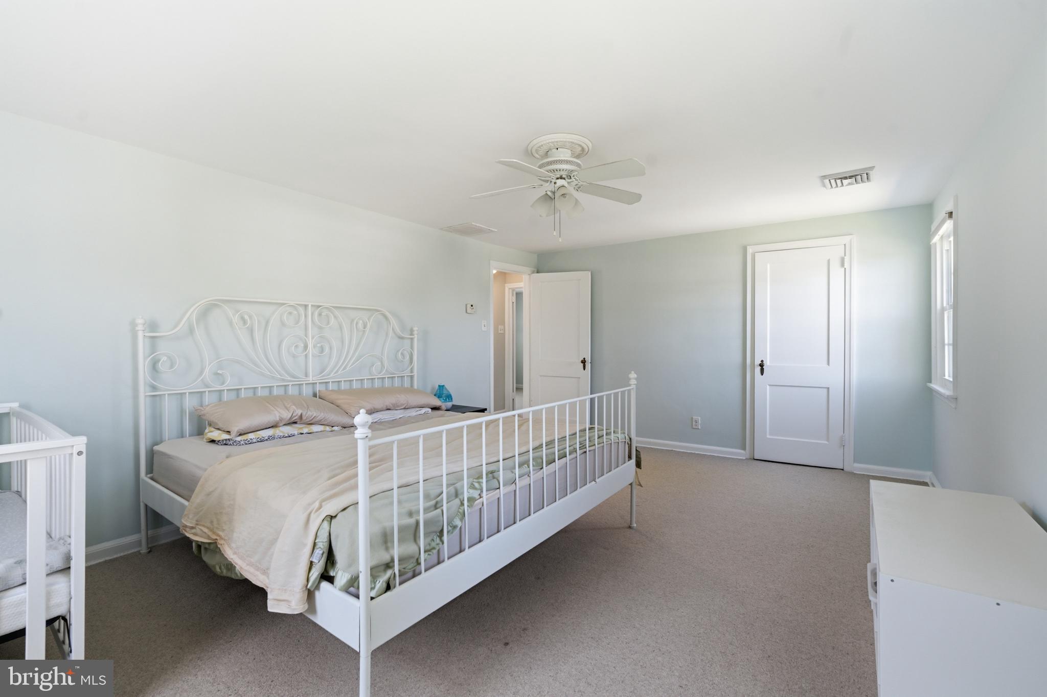 308 Canterbury Road Havertown, PA 19083 - Photo 16 of 26 a bedroom with a bed and a chandelier