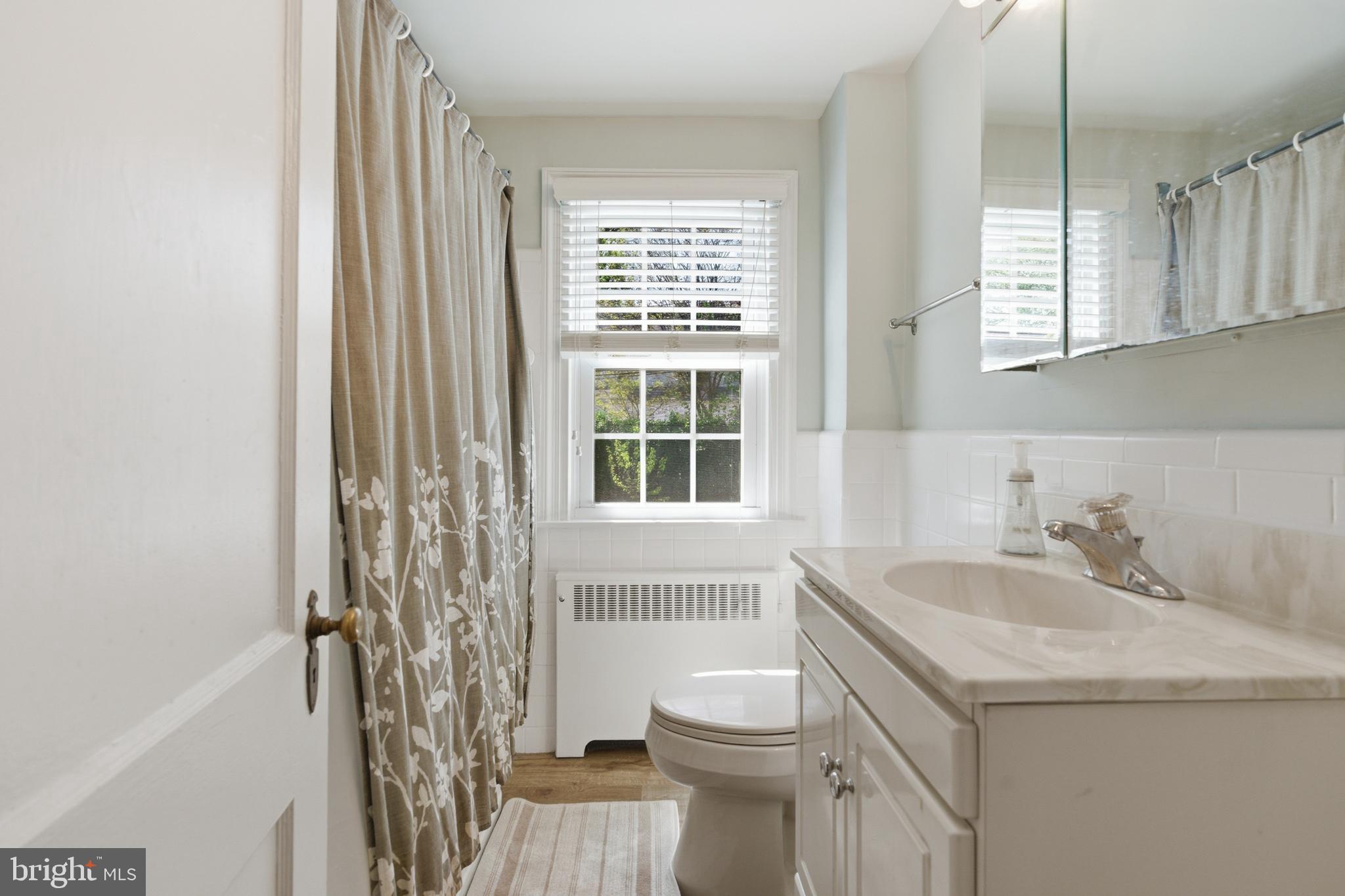 308 Canterbury Road Havertown, PA 19083 - Photo 17 of 26 a bathroom with a sink toilet and window