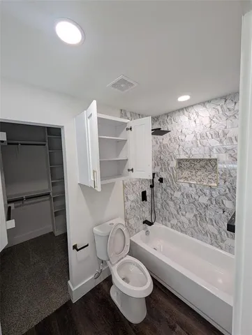 a bathroom with a toilet a sink and bathtub