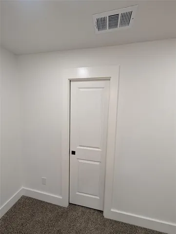 a large kitchen with a large counter top a sink stainless steel appliances and cabinets