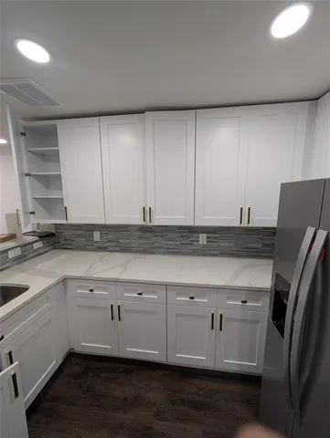 a view of an empty room and wooden floor