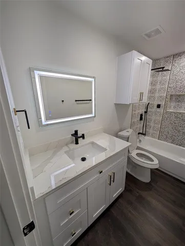 a view of a room with wooden floor and a window