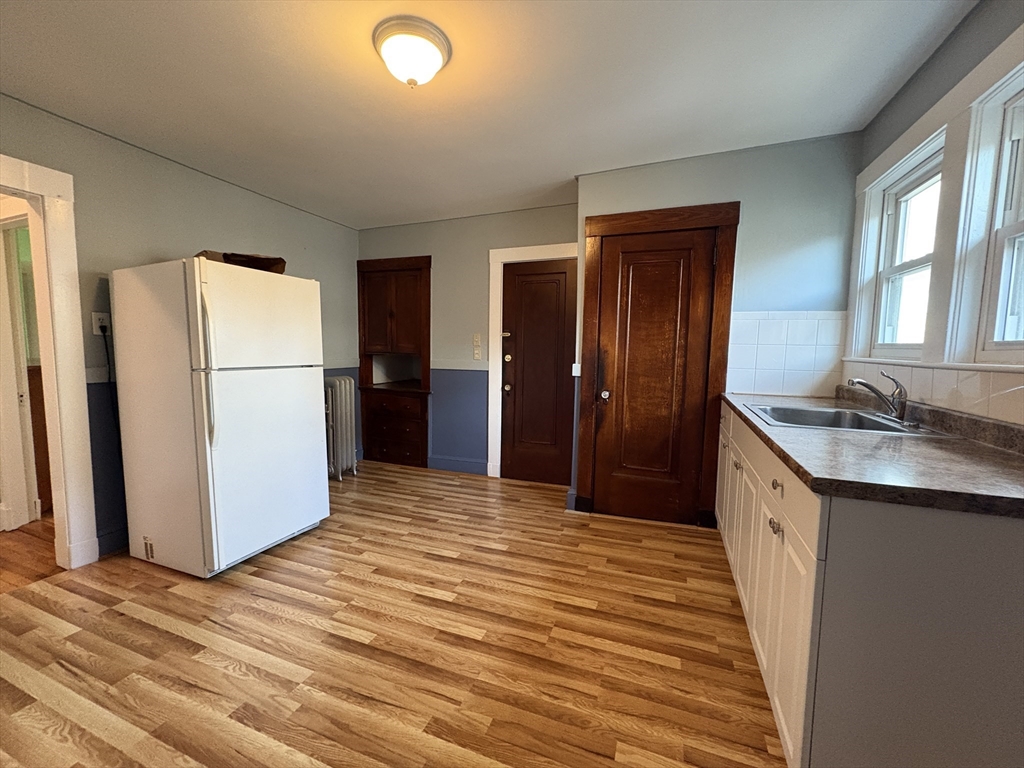 155-157 Hillside Street, Unit 2 Boston, MA 02120 - Photo 8 of 15 a kitchen with a refrigerator and countertop wooden floor