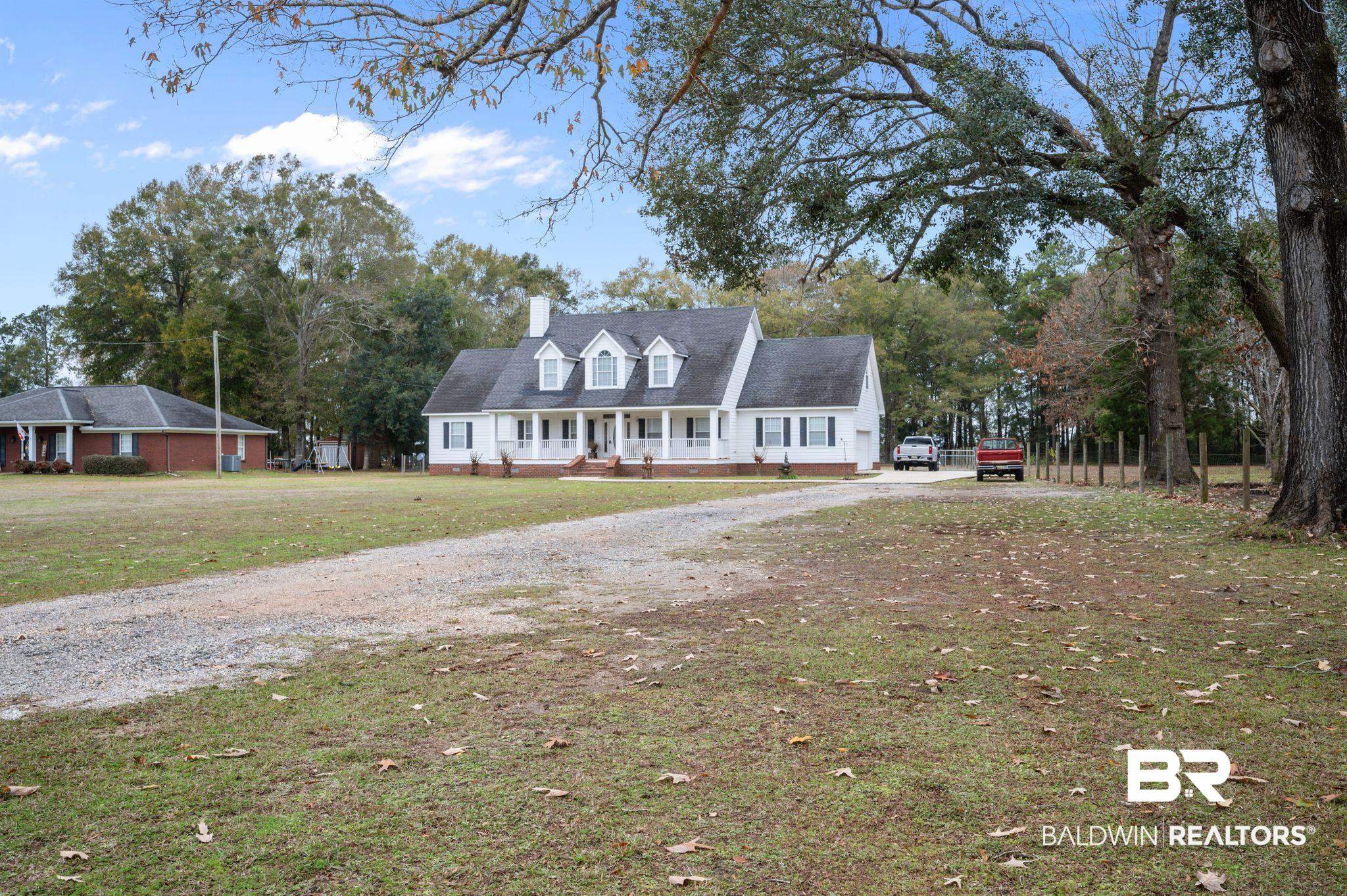 9539 Lakeview Road Bay Minette, AL 36507 - Photo 2 of 45 Cape cod-style house with a porch and a front yard