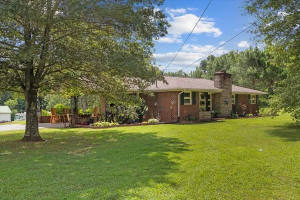 a front view of a house with a garden