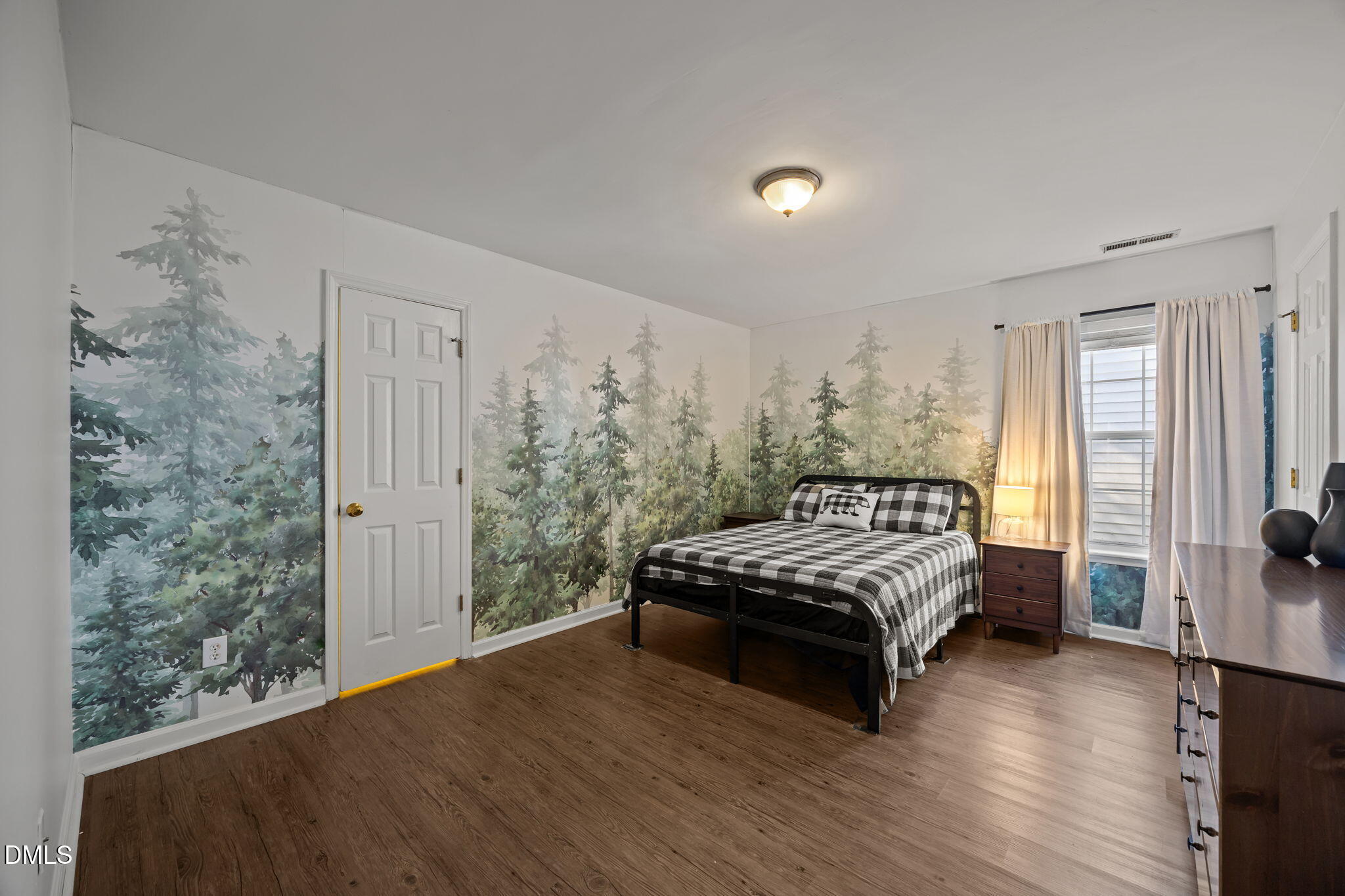 2208 Walnut Ridge Court Raleigh, NC 27610 - Photo 18 of 24 a spacious bedroom with a bed and wooden floor