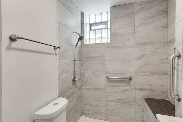 a bathroom with a toilet and a shower