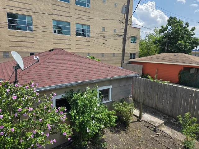 a aerial view of a house with a yard and potted plants