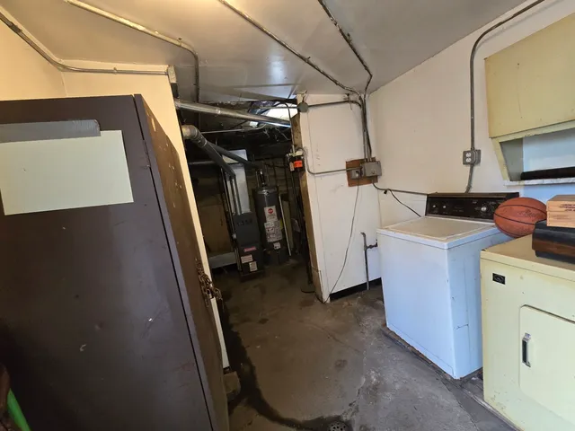 a view of a storage and utility room with washer and dryer