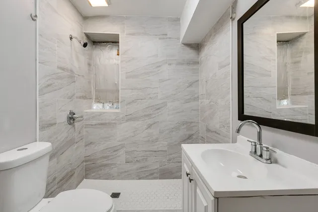 a bathroom with a sink toilet and shower